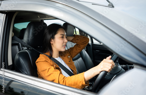 Young asian woman has broken down car on the road she feeling serious and stressed.Look for someone help. Driving during rush hour But the traffic is very congested. Shocked face © Chanakon