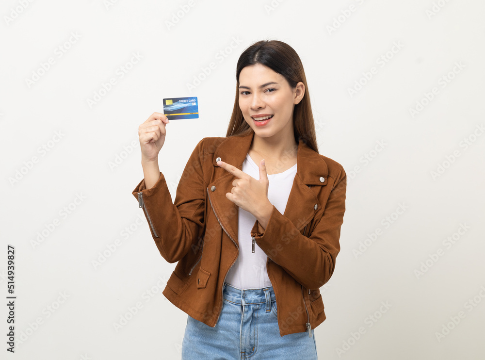 Portrait beautiful women in jacket fashion jean standing pose holding credit card to shopping payment. Attractive Happy businesswoman with creditcard. Portrait beautiful women in jacket fashion jean standing pose holding credit card to shopping payment. Attractive Happy businesswoman with creditcard.