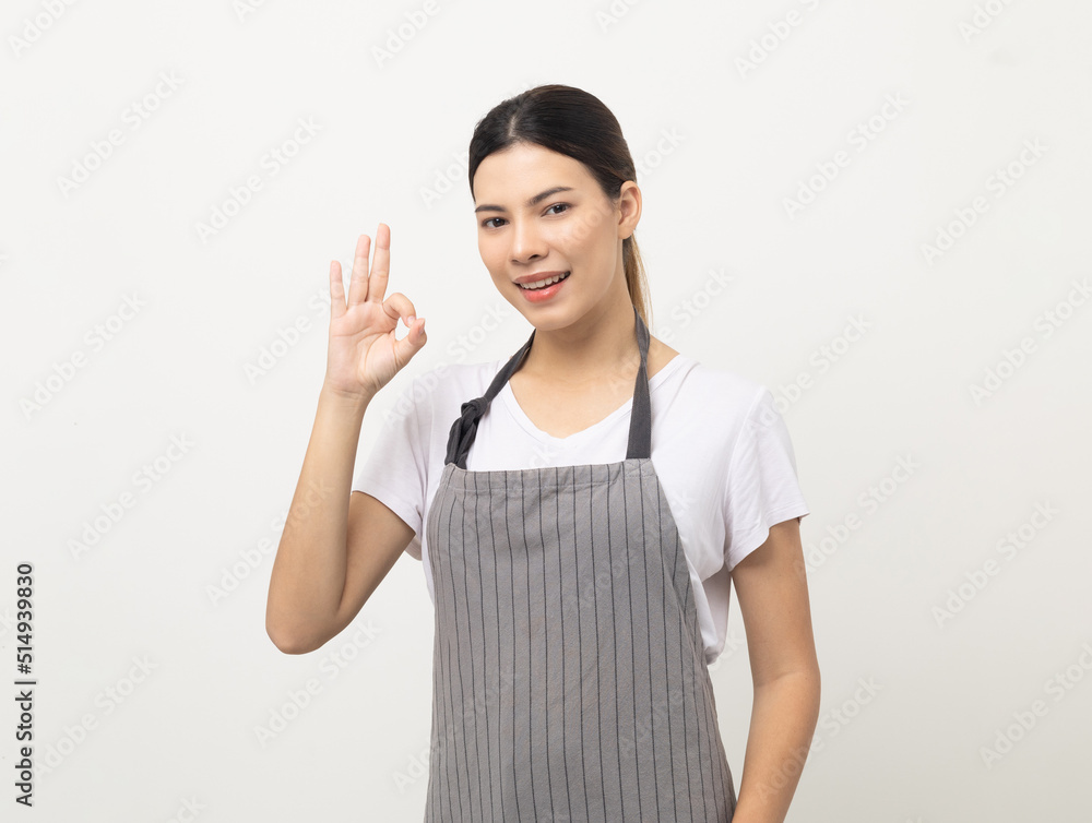 Young beautiful woman with apron standing on isolated white background showing ok sign. Housekeeping housework or maid worker concept. Young beautiful woman with apron standing on isolated white background showing ok sign. Housekeeping housework or maid worker concept.
