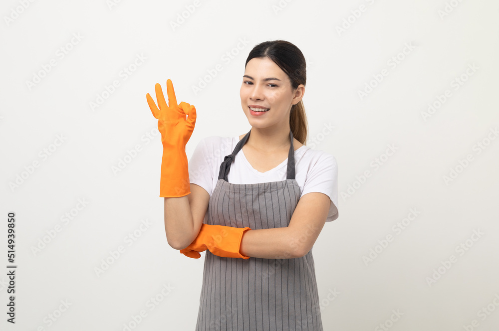 Young beautiful woman with apron and rubber glove standing on isolated white background showing ok sign. Housekeeping housework or maid worker concept. Young beautiful woman with apron and rubber glove standing on isolated white background showing ok sign. Housekeeping housework or maid worker concept.