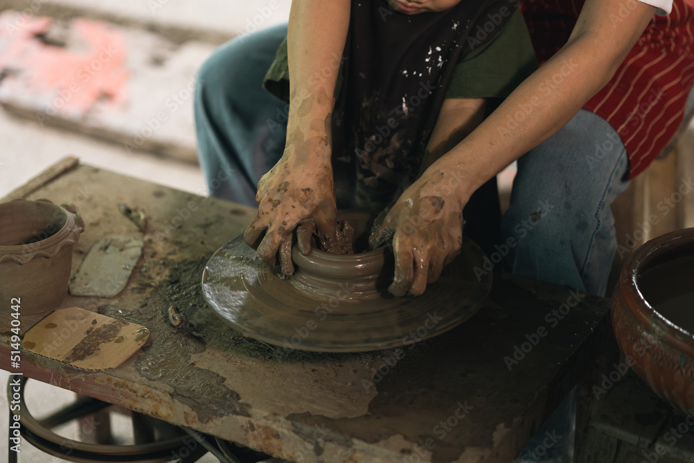 Happy family moment Mother and little boy crafting pottery clay workshop. Child creative activities and art. Kid playing modeling clay in pottery workshop. Developing children's learning skills.