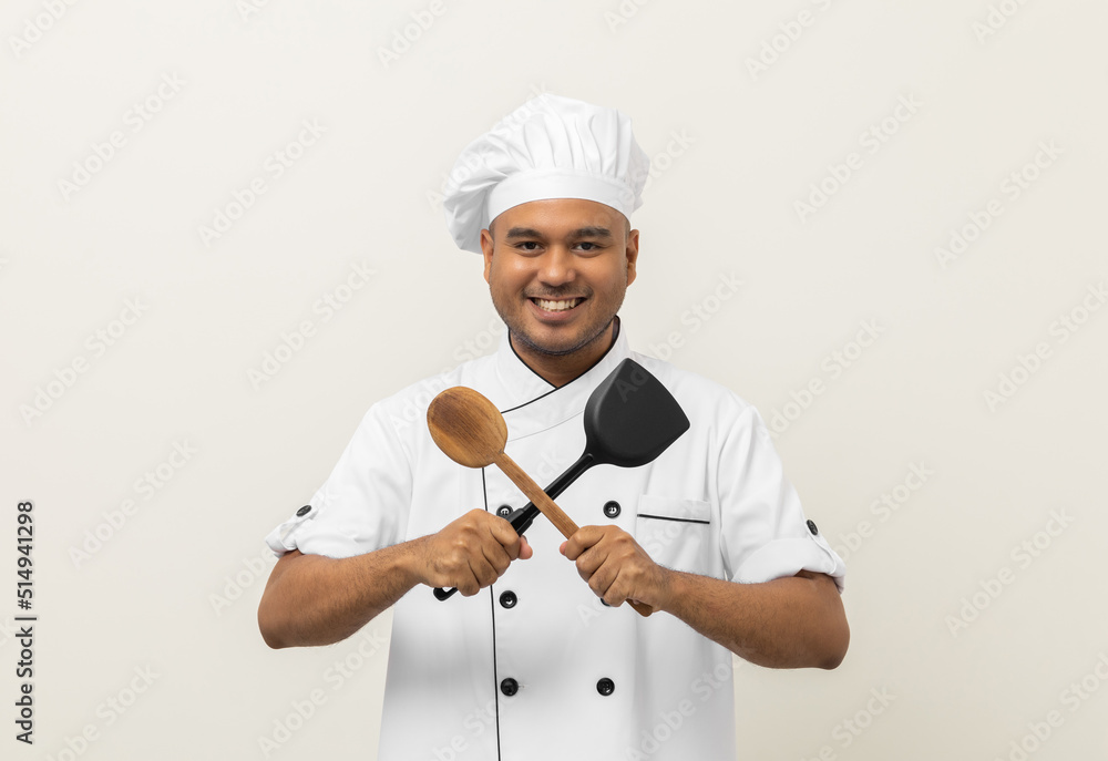 Young handsome asian man chef in uniform holding turner and ladle utensils cooking in the kitchen various gesture action on isolated background. Indian man Occupation chef restaurant and hotel. Young handsome asian man chef in uniform holding turner and ladle utensils cooking in the kitchen various gesture action on isolated background. Indian man Occupation chef restaurant and hotel.