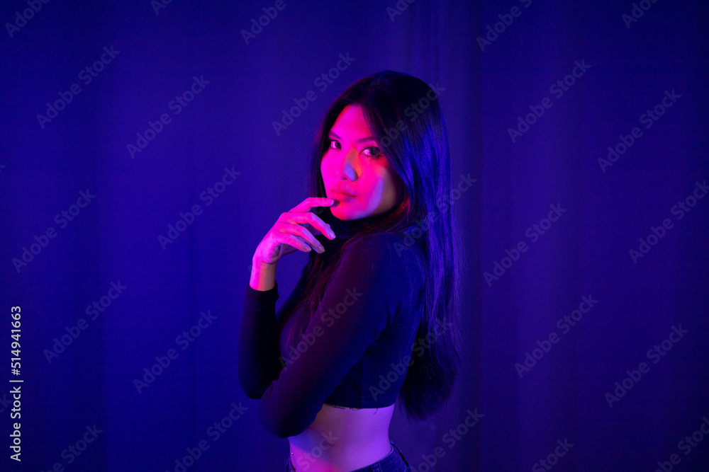 Stylish sexy woman in trendy. Beautiful young asian woman standing pose with neon light. Asia Pretty asian female in the dark room. Fashion shot. Stylish sexy woman in trendy. Beautiful young asian woman standing pose with neon light. Asia Pretty asian female in the dark room. Fashion shot.