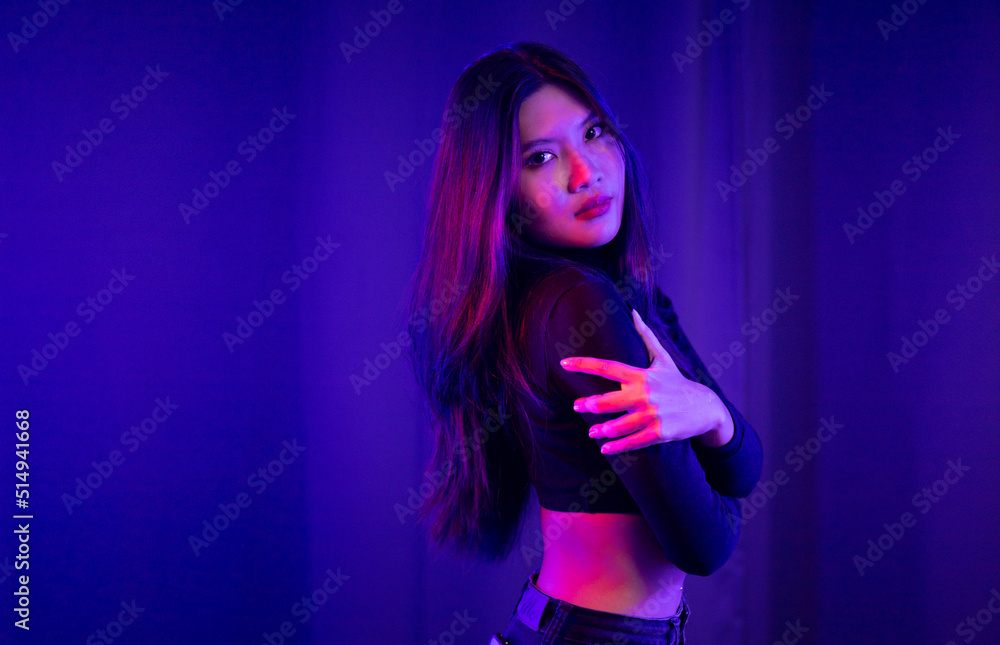 Stylish sexy woman in trendy. Beautiful young asian woman standing pose with neon light. Asia Pretty asian female in the dark room. Fashion shot. Stylish sexy woman in trendy. Beautiful young asian woman standing pose with neon light. Asia Pretty asian female in the dark room. Fashion shot.