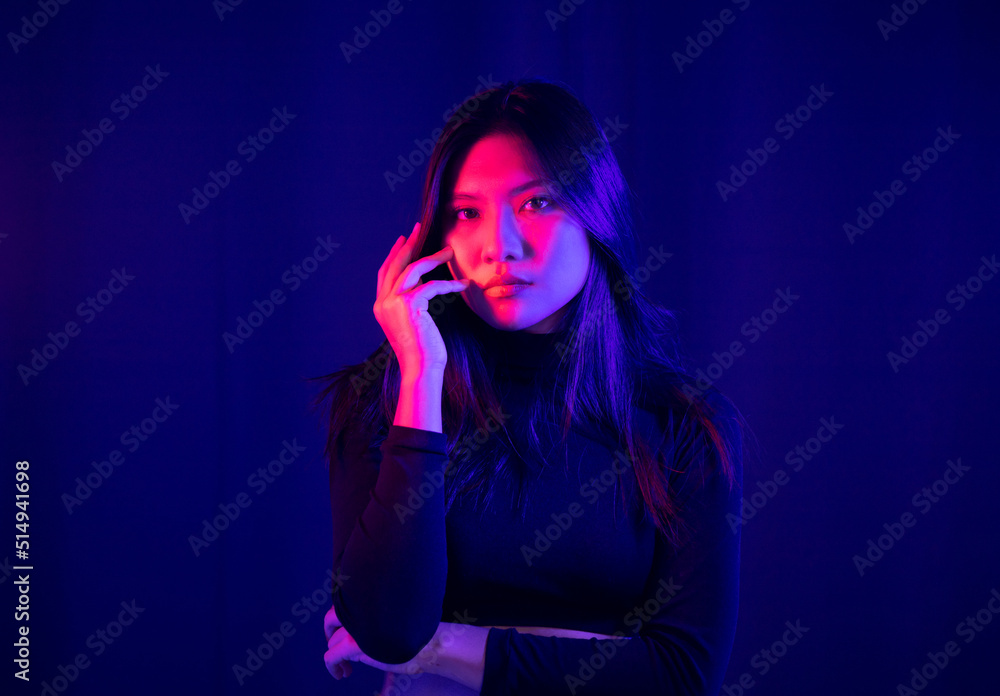 Stylish sexy woman in trendy. Beautiful young asian woman standing pose with neon light. Asia Pretty asian female in the dark room. Fashion shot. Stylish sexy woman in trendy. Beautiful young asian woman standing pose with neon light. Asia Pretty asian female in the dark room. Fashion shot.