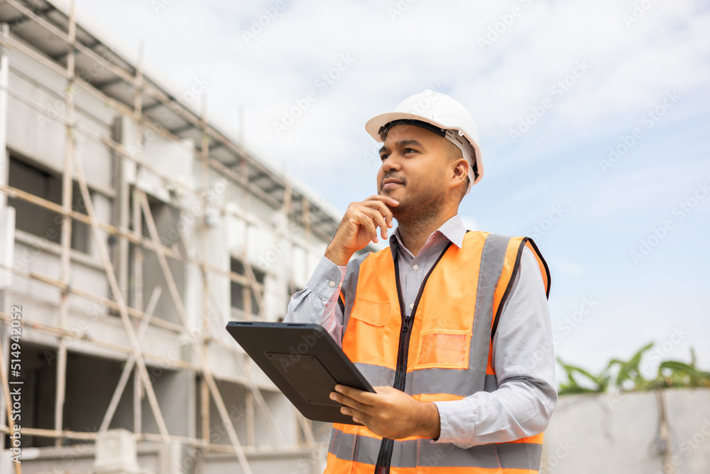 Confident asian engineer man Using tablet for checking and maintenance to inspection at modern home building construction. Architect working with white safety helmet in construction site Confident asian engineer man Using tablet for checking and maintenance to inspection at modern home building construction. Architect working with white safety helmet in construction site