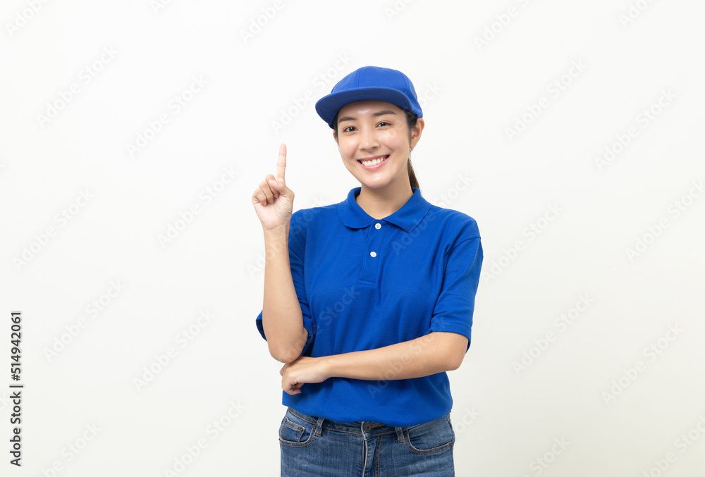 Happy delivery asian woman in blue uniform standing pointing the finger to blank space for text advertise on isolated white background. Smiling female delivery service worker. Happy delivery asian woman in blue uniform standing pointing the finger to blank space for text advertise on isolated white background. Smiling female delivery service worker.