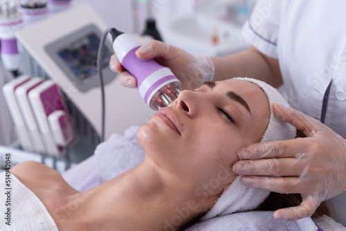 Фотография A young woman undergoing a facial radiofrequency face lift treatment