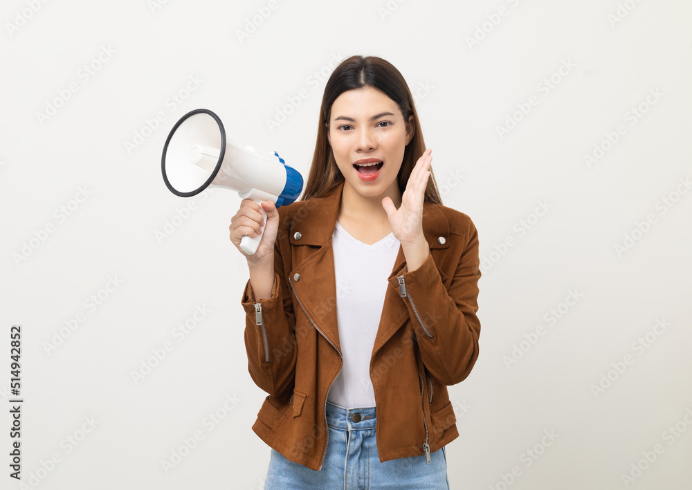 Shout out loud with megaphone. Young beautiful mixed race woman announces with a voice about promotions and advertisements for products at a discounted price. Standing on isolated white background. Shout out loud with megaphone. Young beautiful mixed race woman announces with a voice about promotions and advertisements for products at a discounted price. Standing on isolated white background.