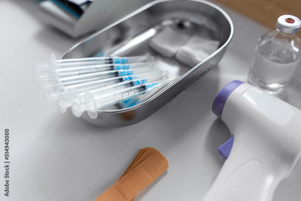 medicine, vaccination and healthcare concept - disposable syringes and other stuff on table at hospital medicine, vaccination and healthcare concept - disposable syringes and other stuff on table at hospital