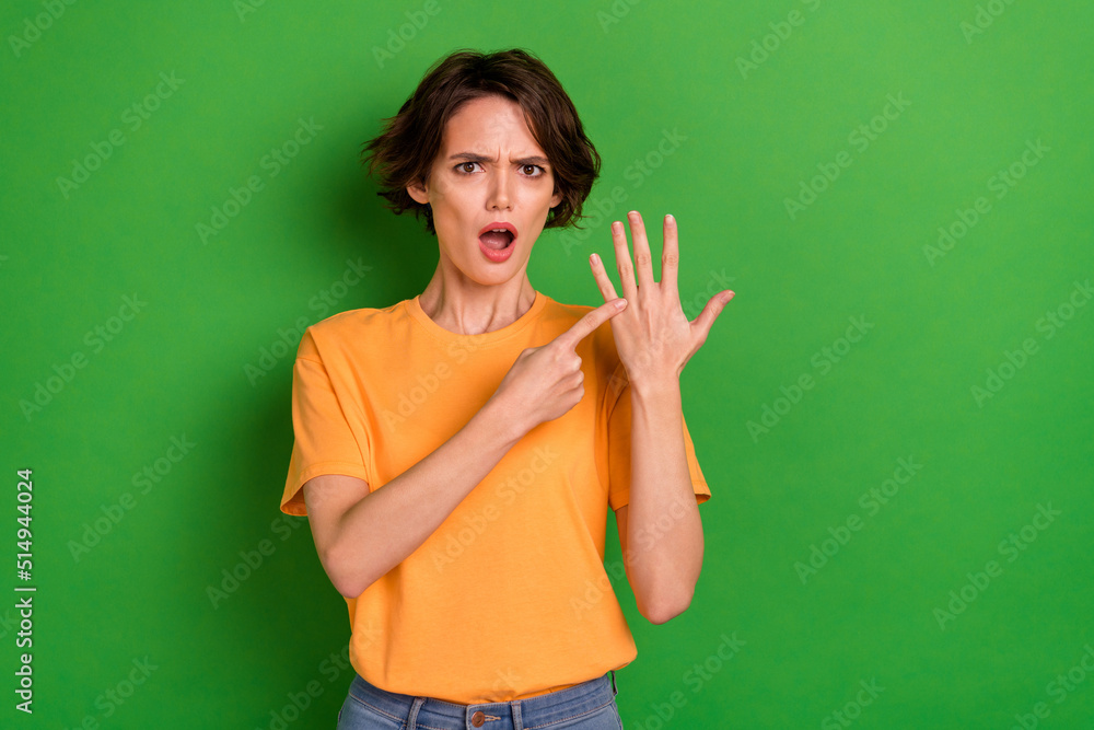 Portrait of unsatisfied lady demonstrate no ring finger isolated on green color background Portrait of unsatisfied lady demonstrate no ring finger isolated on green color background