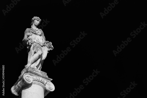 Abundantia, ancient roman goddess of abundance, wealth, money, prosperity, fortune, and success. A 15th century statue erected in the Pisa historical center (Black and White with copy space)