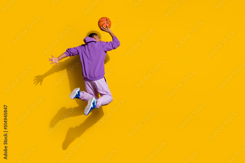 Full length body size view of handsome trendy guy jumping playing copy space isolated on bright yellow color background