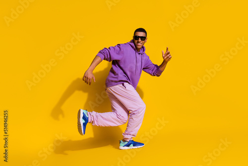Full length body size view of attractive trendy guy dancing copy space luck isolated on bright yellow color background