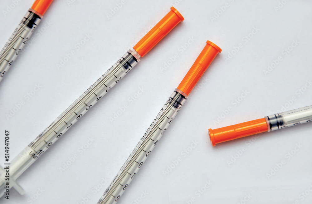 insulin syringes on a light background, medical background with syringes insulin syringes on a light background, medical background with syringes
