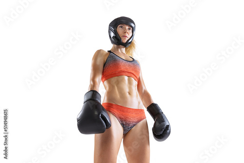 Sportive woman, female professional kickboxer in sports gloves and protective helmet posing isolated on white background. Sport, achievements concept © master1305
