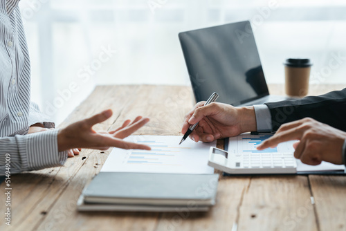 Business people working in the office discussing documents and ideas at meeting, Asian business advisor meeting to analyze and discuss the situation on the financial report.