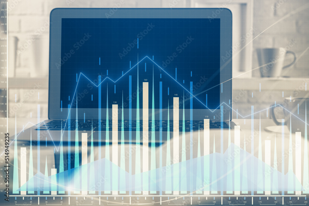 Stock market chart hologram drawn on personal computer background. Multi exposure. Concept of investment. Stock market chart hologram drawn on personal computer background. Multi exposure. Concept of investment.