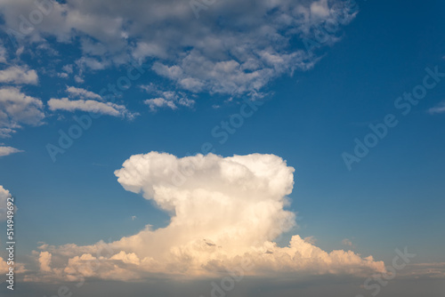 A big white cloud in a bright blue sky. © maykal