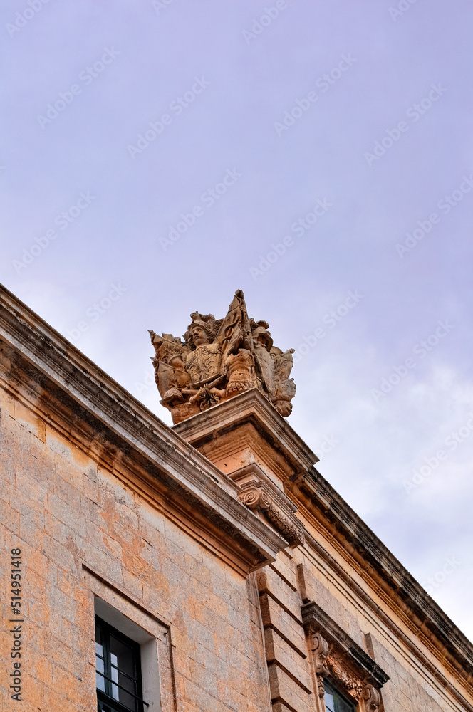 A statue adorning the roof of an old building in Mdina, or the Silent City. Malta, Europe.