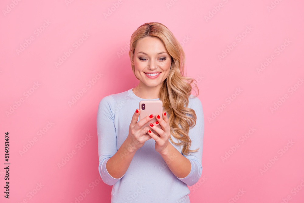 Portrait of cheerful pretty girl hold use telephone toothy smile isolated on pink color background Portrait of cheerful pretty girl hold use telephone toothy smile isolated on pink color background