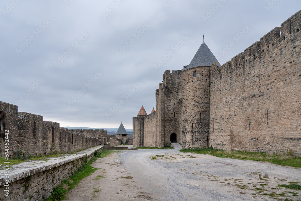 Outer bailey of the walled medieval city of Carcassonne with no people and an overcast sky