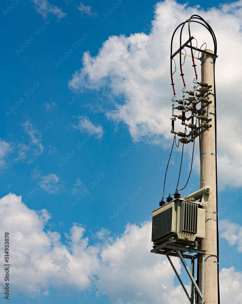 Private electrical transformer mounted on a special pole against the sky Private electrical transformer mounted on a special pole against the sky