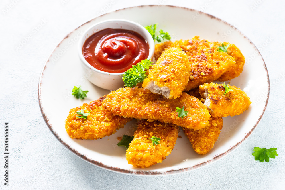 Chicken nuggets with ketchup sauce at white table. Chicken nuggets with ketchup sauce at white table.