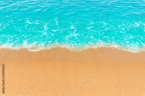Blue sea wave,golden sand beach,white foam,turquoise ocean water.Close-up.Summer holidays concept.Tropical island vacation backdrop,tourist travel banner design template, copy space.