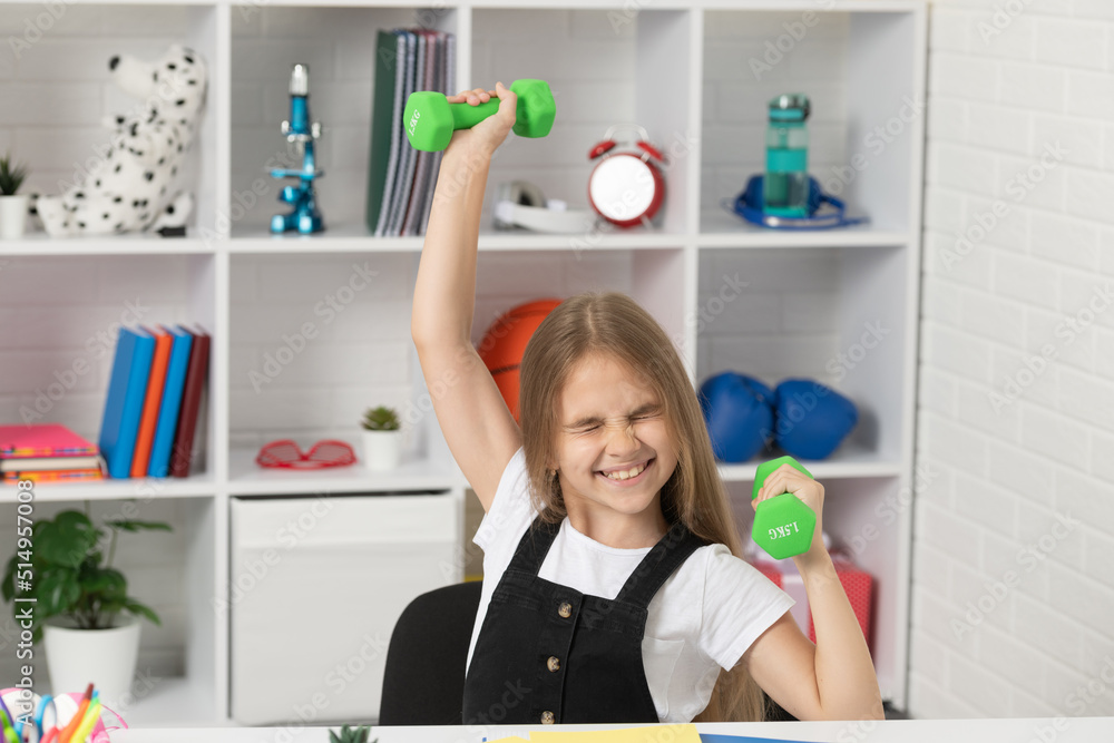 strong child hold barbells in school classroom strong child hold barbells in school classroom