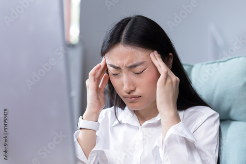 Fényképezés Close-up photo of business woman tired in office, Asian female worker holding ha