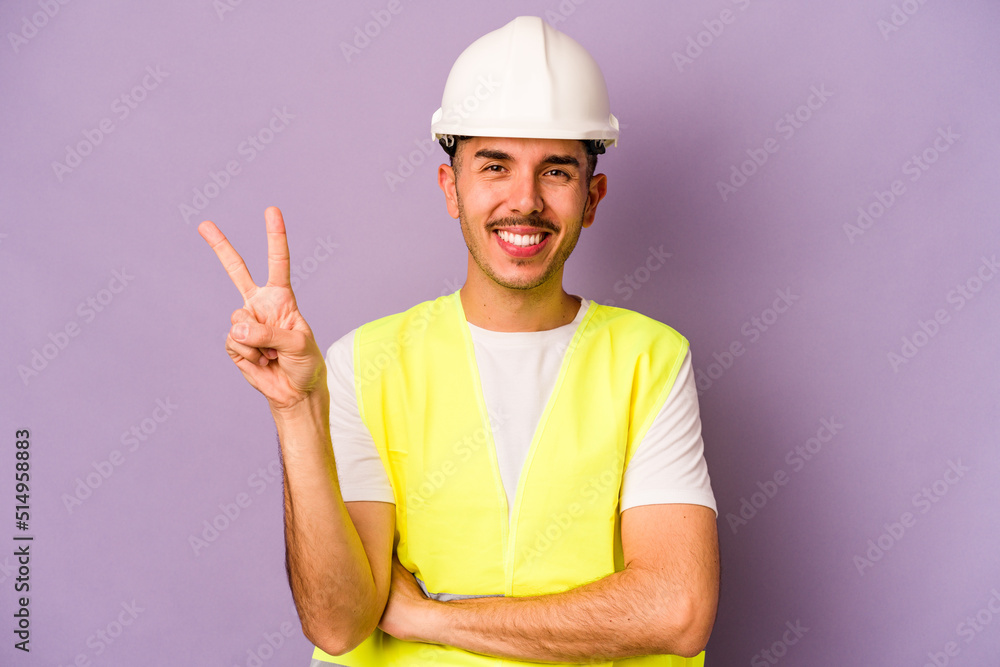 Young hispanic worker man isolated on purple background showing number two with fingers.