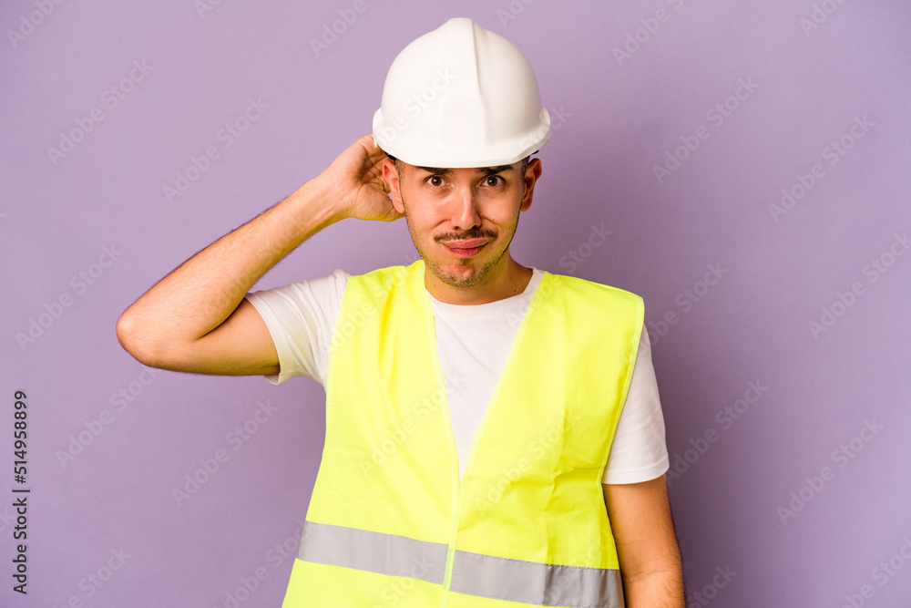 Young hispanic worker man isolated on purple background being shocked, she has remembered important meeting.