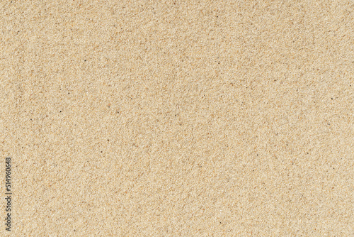 Sand beach texture background. Light hot sand on the sea coast in summer.