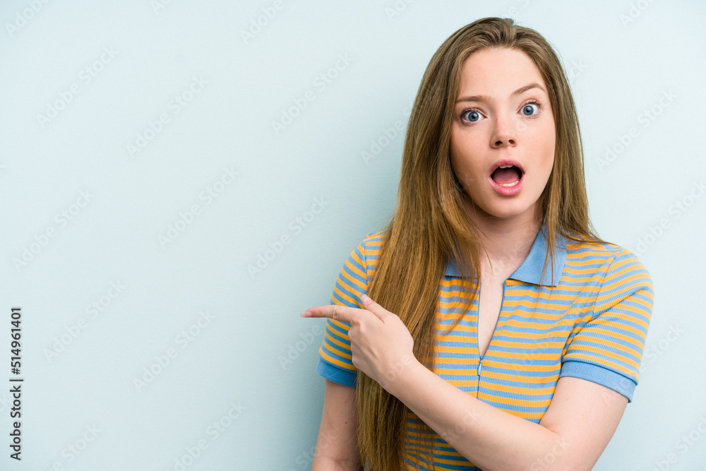 Young caucasian woman isolated on blue background pointing to the side Young caucasian woman isolated on blue background pointing to the side