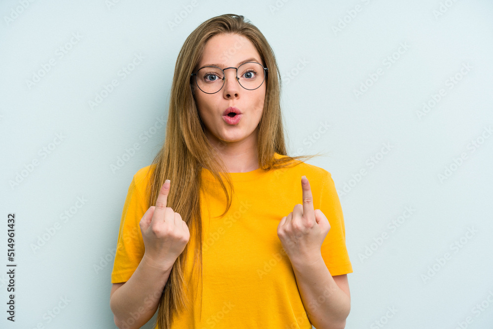 Obraz premium Young caucasian woman isolated on blue background pointing upside with opened mouth.