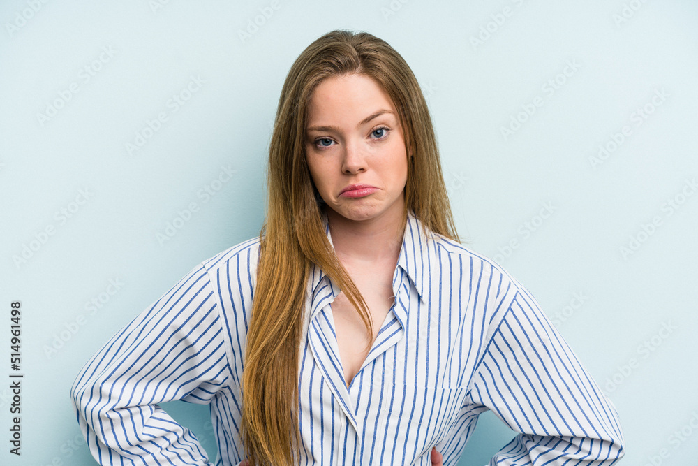 Young caucasian woman isolated on blue background sad, serious face, feeling miserable and displeased. Young caucasian woman isolated on blue background sad, serious face, feeling miserable and displeased.