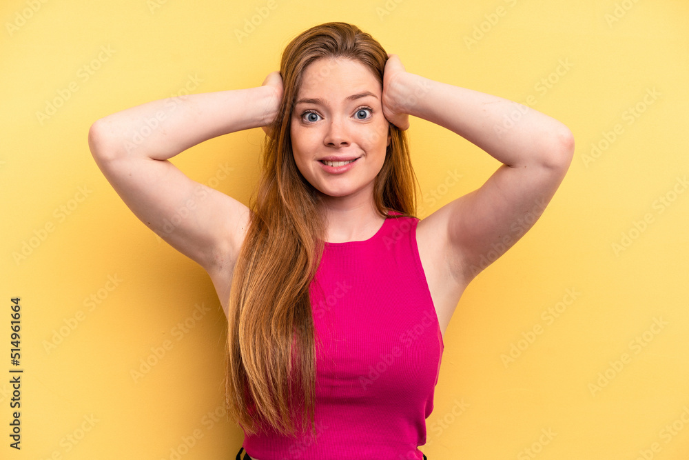 Young caucasian woman isolated on yellow background screaming with rage. Young caucasian woman isolated on yellow background screaming with rage.
