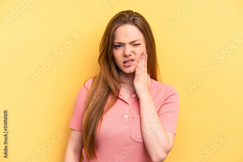 Young caucasian woman isolated on yellow background having a strong teeth pain, molar ache.