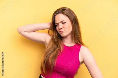Young caucasian woman isolated on yellow background tired and very sleepy keeping hand on head.