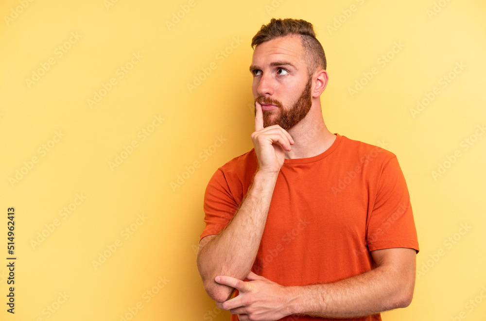 Young caucasian man isolated on yellow background looking sideways with doubtful and skeptical expression. Young caucasian man isolated on yellow background looking sideways with doubtful and skeptical expression.