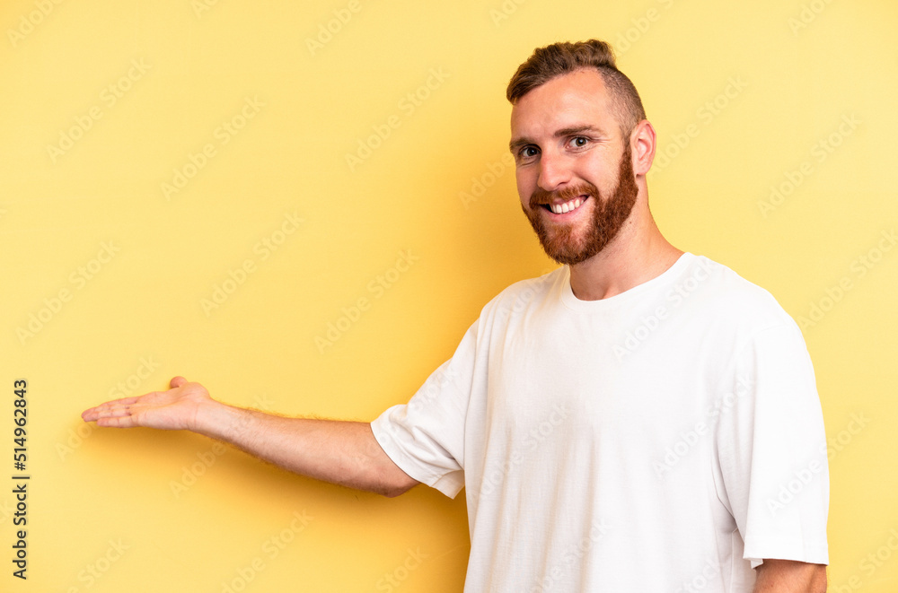 Young caucasian man isolated on yellow background showing a welcome expression.