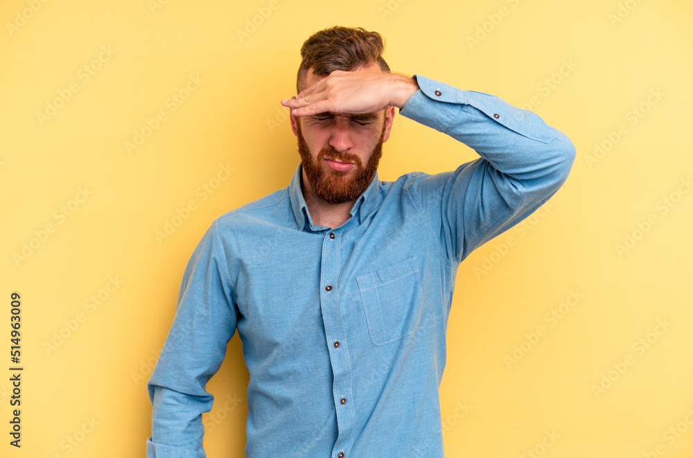 Young caucasian man isolated on yellow background touching temples and having headache. Young caucasian man isolated on yellow background touching temples and having headache.