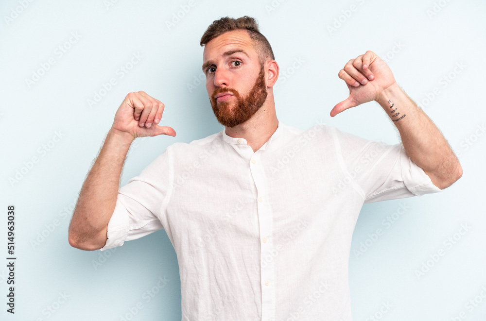 Fototapeta premium Young caucasian man isolated on blue background feels proud and self confident, example to follow.