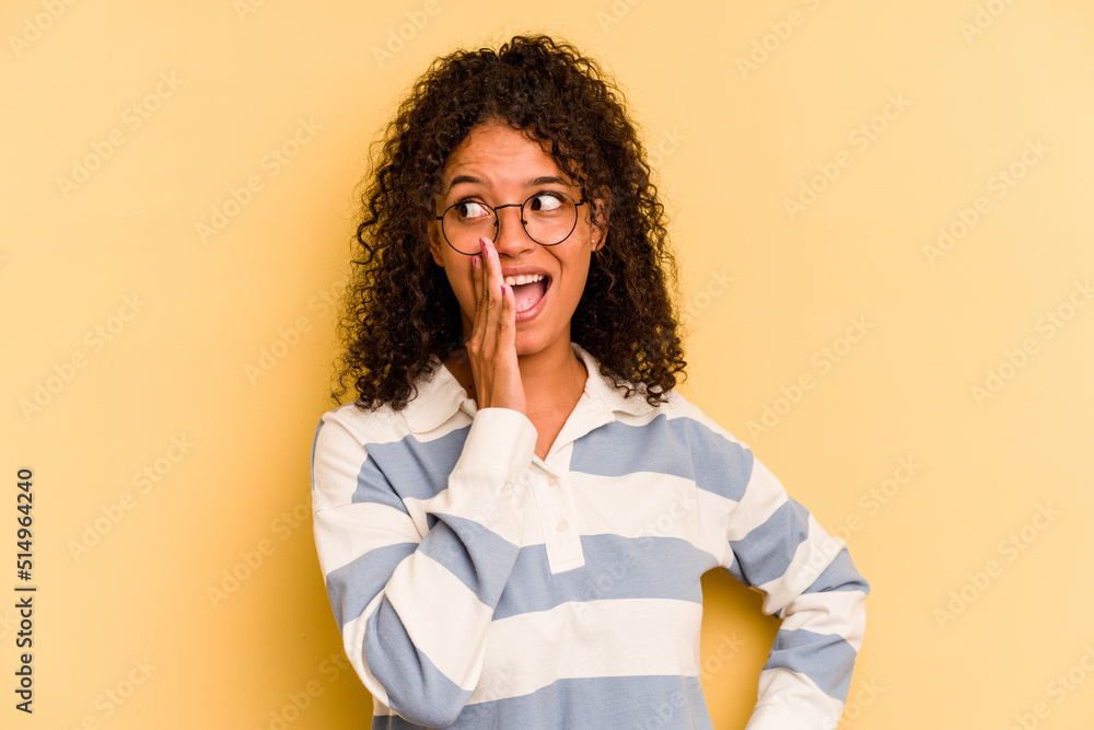 Young Brazilian woman isolated on yellow background shouting excited to front. Young Brazilian woman isolated on yellow background shouting excited to front.