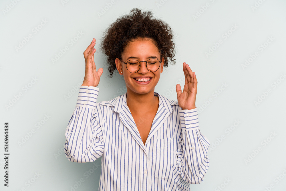 Young Brazilian woman isolated on blue background joyful laughing a lot. Happiness concept. Young Brazilian woman isolated on blue background joyful laughing a lot. Happiness concept.