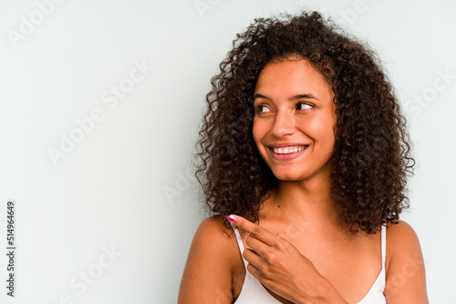 Young Brazilian woman isolated on blue background