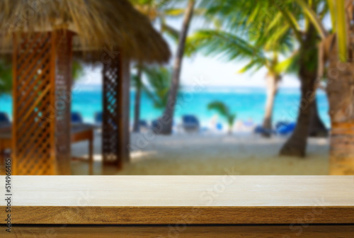 Art Empty wooden table on sunny blurred tropical bar background. Outdoor party mockup for design and product display.