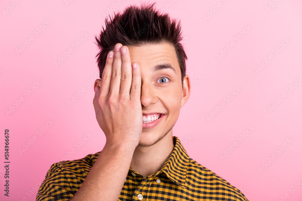 Handsome man wearing casual clothes covering one eye with hand confident smile on face isolated pastel color background Handsome man wearing casual clothes covering one eye with hand confident smile on face isolated pastel color background