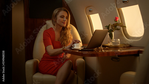 Fotografie Entrepreneur working laptop computer on corporate first class journey alone